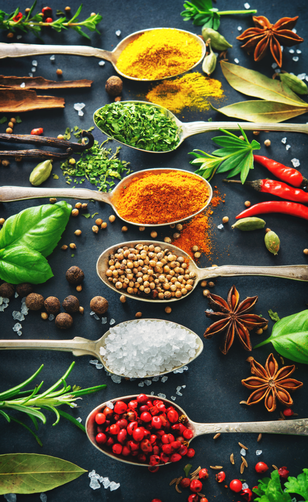 Various herbs and spices on dark background